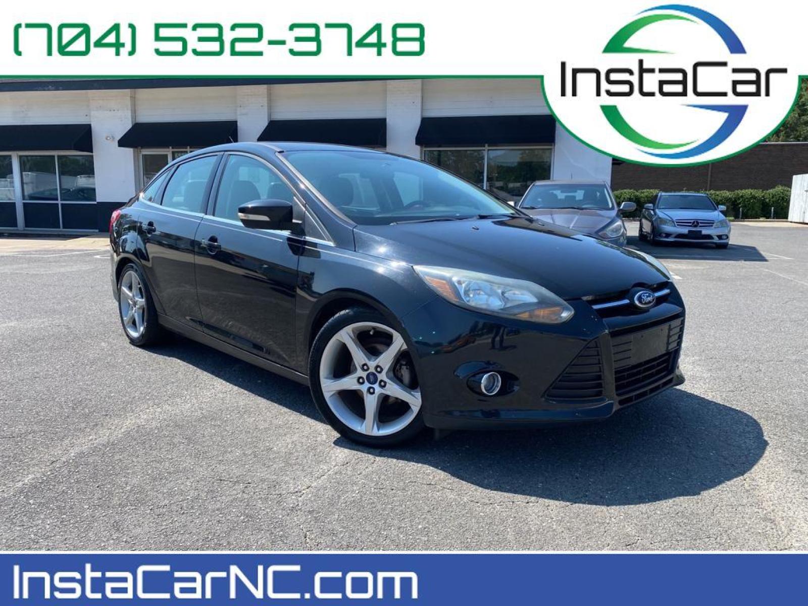 2014 Tuxedo Black Metallic /Charcoal Black Ford Focus Titanium (1FADP3J29EL) with an L4, 2.0L engine, 6-speed auto-shift manual transmission, located at 3147 E Independence Blvd, Charlotte, NC, 28205, 35.200268, -80.773651 - <b>Equipment</b><br>Enjoy your music even more with the premium sound system in this model. The installed navigation system will keep you on the right path. Bluetooth technology is built into this unit, keeping your hands on the steering wheel and your focus on the road. See what's behind you with t - Photo #0