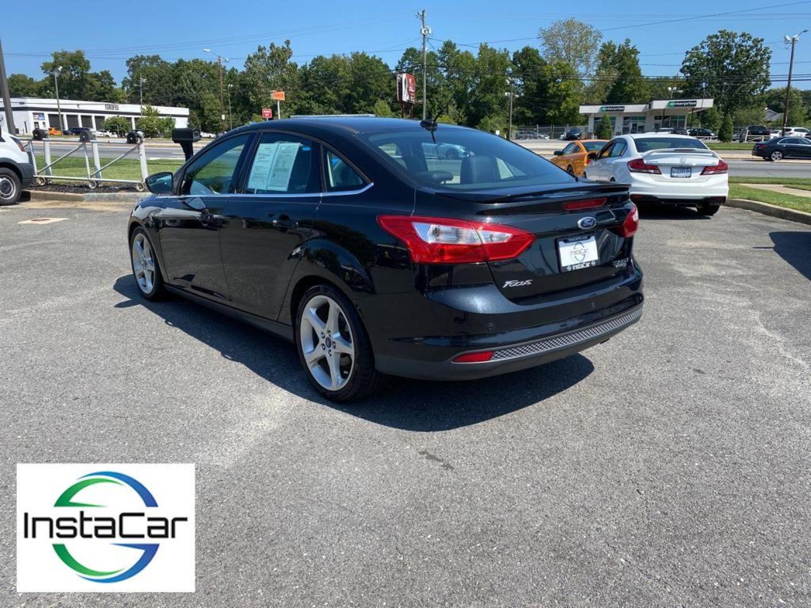 2014 Tuxedo Black Metallic /Charcoal Black Ford Focus Titanium (1FADP3J29EL) with an L4, 2.0L engine, 6-speed auto-shift manual transmission, located at 3147 E Independence Blvd, Charlotte, NC, 28205, 35.200268, -80.773651 - <b>Equipment</b><br>Enjoy your music even more with the premium sound system in this model. The installed navigation system will keep you on the right path. Bluetooth technology is built into this unit, keeping your hands on the steering wheel and your focus on the road. See what's behind you with t - Photo #9