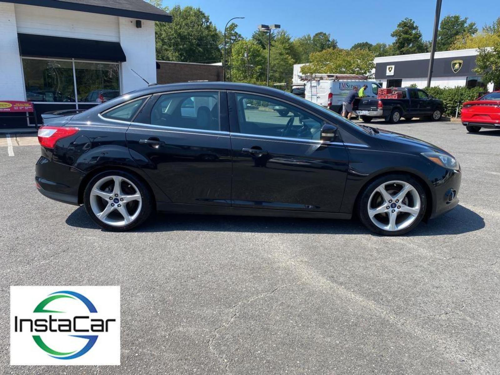 2014 Tuxedo Black Metallic /Charcoal Black Ford Focus Titanium (1FADP3J29EL) with an L4, 2.0L engine, 6-speed auto-shift manual transmission, located at 3147 E Independence Blvd, Charlotte, NC, 28205, 35.200268, -80.773651 - <b>Equipment</b><br>Enjoy your music even more with the premium sound system in this model. The installed navigation system will keep you on the right path. Bluetooth technology is built into this unit, keeping your hands on the steering wheel and your focus on the road. See what's behind you with t - Photo #12
