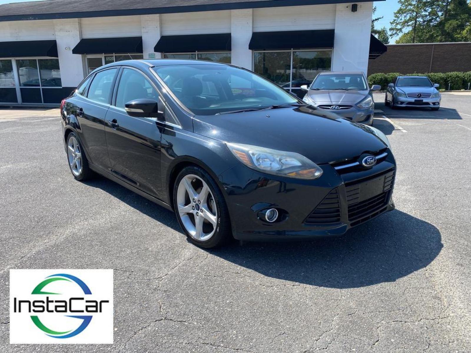 2014 Tuxedo Black Metallic /Charcoal Black Ford Focus Titanium (1FADP3J29EL) with an L4, 2.0L engine, 6-speed auto-shift manual transmission, located at 3147 E Independence Blvd, Charlotte, NC, 28205, 35.200268, -80.773651 - <b>Equipment</b><br>Enjoy your music even more with the premium sound system in this model. The installed navigation system will keep you on the right path. Bluetooth technology is built into this unit, keeping your hands on the steering wheel and your focus on the road. See what's behind you with t - Photo #5