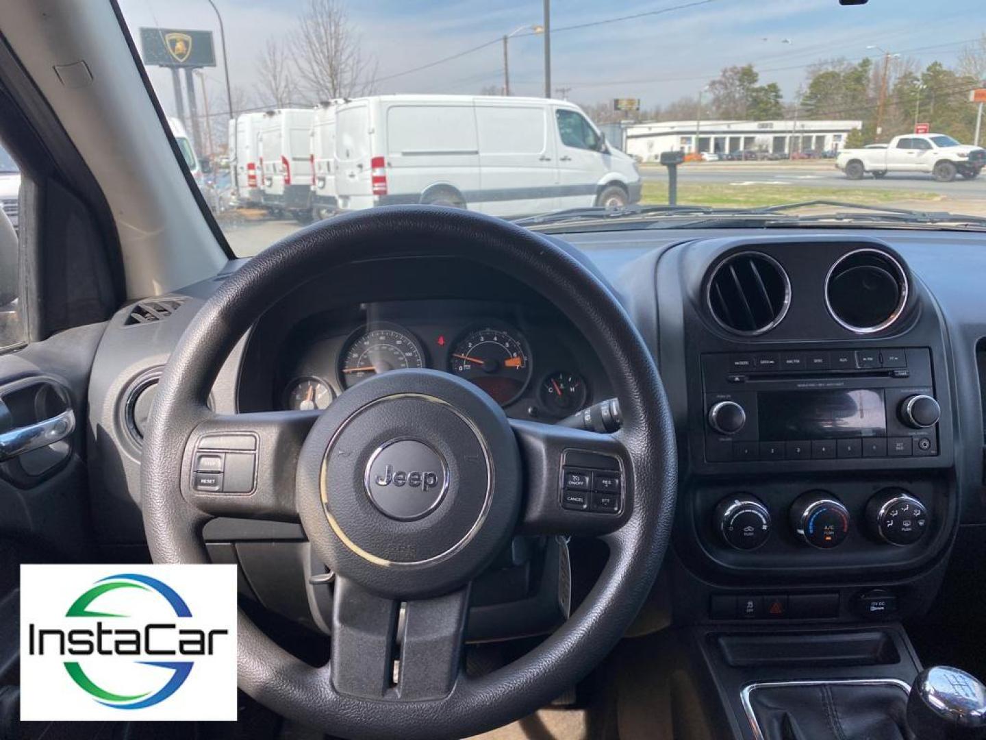 2014 Black Clearcoat /Dark Slate Gray Jeep Compass Sport (1C4NJCBA9ED) with an L4, 2.0L engine, 5-speed manual transmission, located at 3147 E Independence Blvd, Charlotte, NC, 28205, 35.200268, -80.773651 - Introducing the impeccable 2014 Jeep Compass Sport, now available at our esteemed dealership. This used gem has been meticulously maintained and is ready to embark on its next adventure with you. With a remarkable mileage of 179,461 miles, this SUV has proven its reliability and longevity, making it - Photo#2