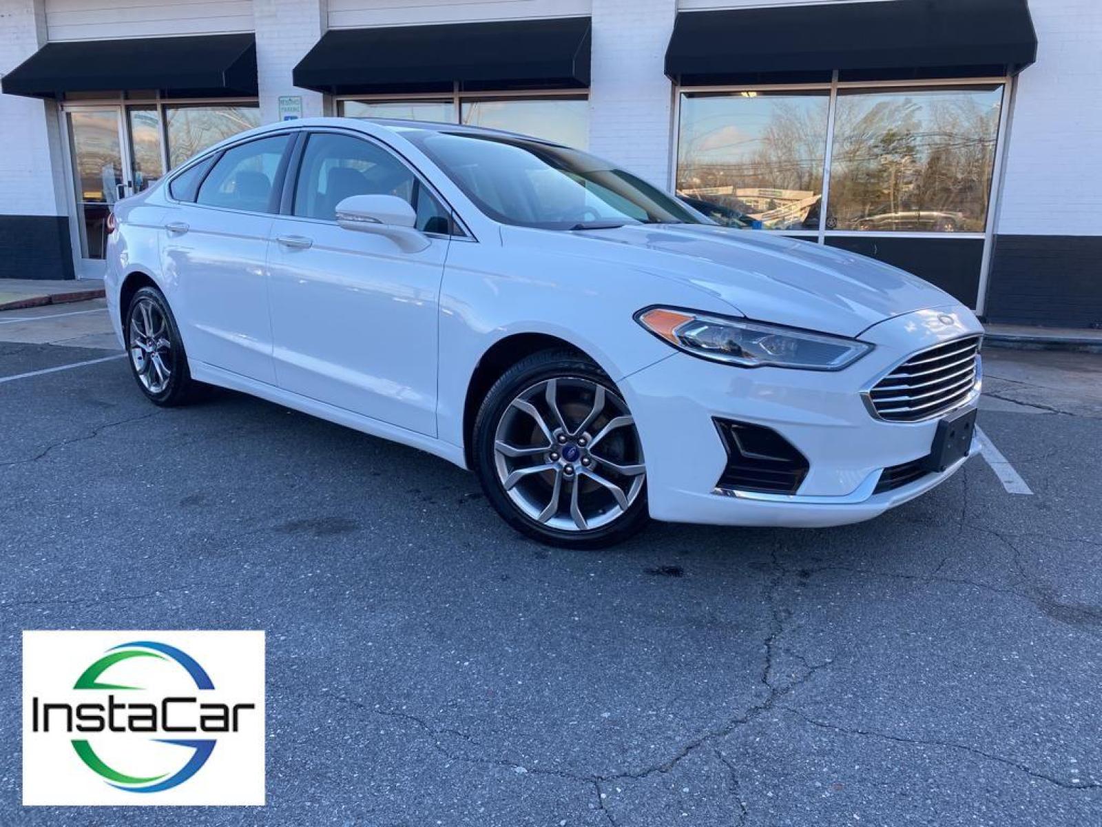 2019 WHITE Ford Fusion SEL (3FA6P0CD0KR) with an 1.5 liter 4 Cylinder Engine engine, 6-SPEED AUTOMATIC W/PADDLE SHIFTERS transmission, located at 3147 E Independence Blvd, Charlotte, NC, 28205, 35.200268, -80.773651 - This vehicle features a hands-free Bluetooth phone system. The rear parking assist technology on this vehicle will put you at ease when reversing. The system alerts you as you get closer to an obstruction. See what's behind you with the back up camera on the Ford Fusion. Front wheel drive on this 2 - Photo #0