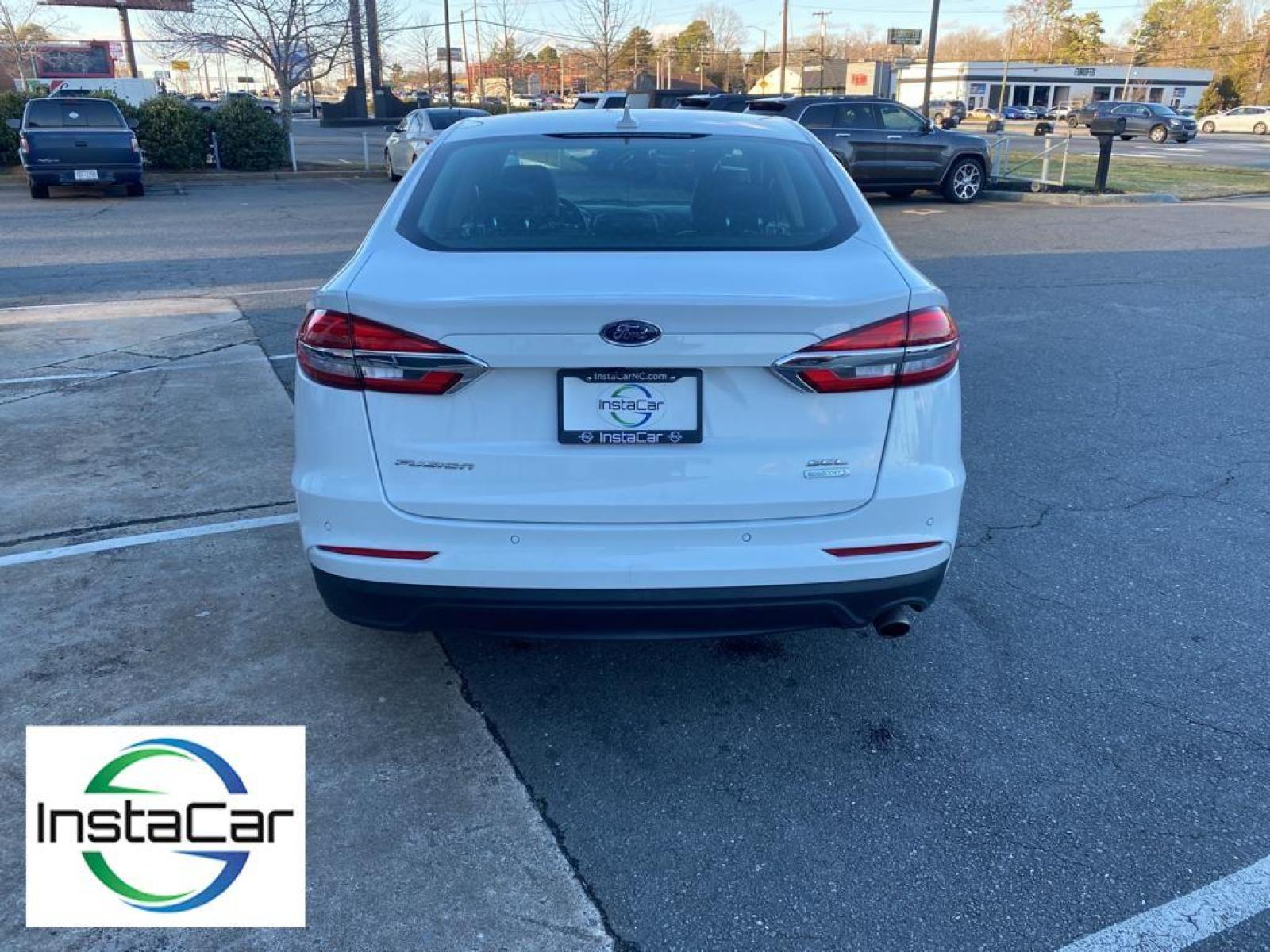 2019 WHITE Ford Fusion SEL (3FA6P0CD0KR) with an 1.5 liter 4 Cylinder Engine engine, 6-SPEED AUTOMATIC W/PADDLE SHIFTERS transmission, located at 3147 E Independence Blvd, Charlotte, NC, 28205, 35.200268, -80.773651 - This vehicle features a hands-free Bluetooth phone system. The rear parking assist technology on this vehicle will put you at ease when reversing. The system alerts you as you get closer to an obstruction. See what's behind you with the back up camera on the Ford Fusion. Front wheel drive on this 2 - Photo #11
